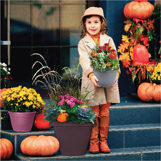 Image of little girl holding planter with flowers